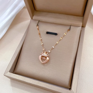 Elegant rose gold titanium crown heart necklace with dancing stone in jewelry box