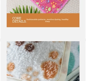 Macro shot of soft flannel pet blanket with colorful paw prints and reinforced edges