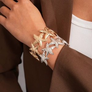 Adjustable seashell and starfish open cuff bracelet with hammered metal texture in gold
