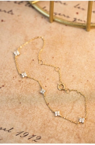 Macro shot of 18K gold plated S925 silver bracelet featuring clover shaped zircon stones