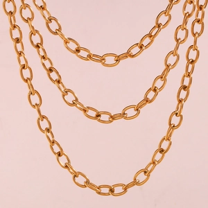 Detailed macro view of 18K gold plated stainless steel chunky oval link chain layers
