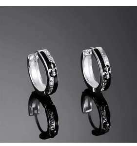 Detailed macro view of hip-hop earrings with Chivalry Spirit engraving and reflections