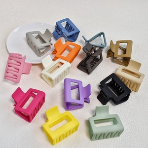Detail view of multi-color matte rectangular hair claws with a strong metal spring