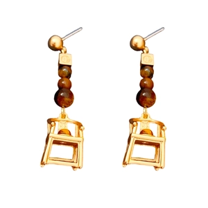 Vintage style gold earrings with brown beads and hollow chair charms on white background