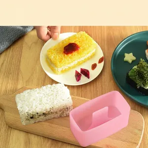 Pink layered rice ball mold tool with press lid for making DIY Japanese triangle sushi