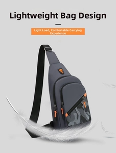 Close-up of lightweight grey men's chest bag with orange zippers and floating feathers