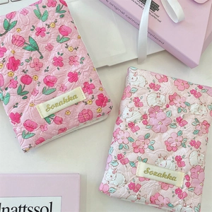 Detailed view of pink quilted floral pouches with cute bunny print and fabric brand tag