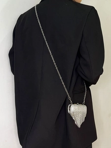 Silver rhinestone lipstick bag with fringe tassels and metal chain on model