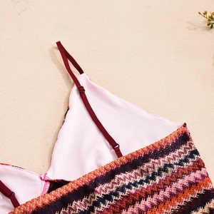 Close-up of colorful crochet knit texture with red adjustable straps and seam detail