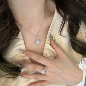 Macro detail of lavender zircon clover pendant necklace and matching silver ring