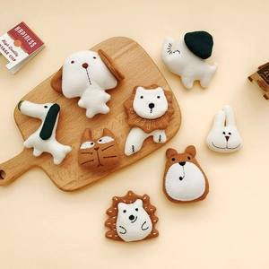 Flat lay of handmade cotton-linen stuffed animal brooches in various cute shapes
