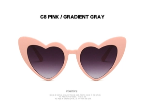 Close-up of pink heart-shaped frame sunglasses with gradient gray polarized lenses