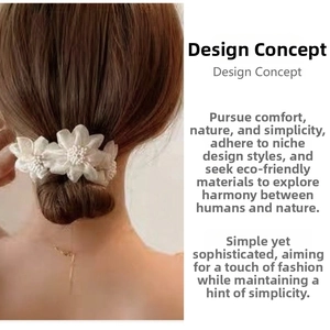 Close-up of elegant white fabric flower hair accessory with delicate faux pearls