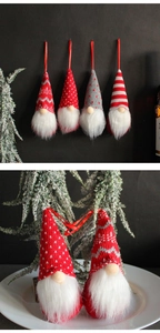 Detail of four knitted forest gnome ornaments with red lanyards on frosty branches