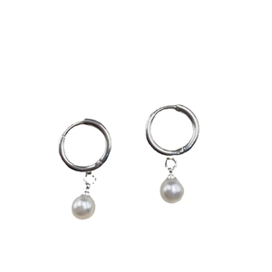 Elegant silver metal hoop earrings with round white pearl pendants on a white background
