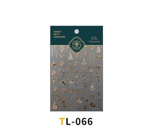 Close-up of golden 3D Christmas nail stickers with snowflake and reindeer patterns