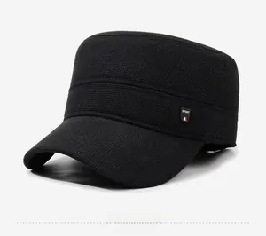 Detail showing the fine woven texture and sport badge on the black flat top military cap