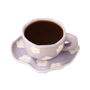 Charming purple ceramic coffee cup and saucer set with elegant white floral patterns