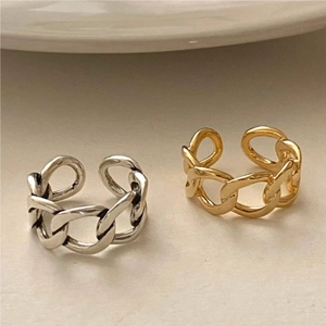 Close-up of minimalist gold and silver S925 sterling silver chain link rings