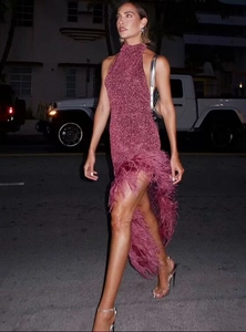 Detail of sequined fabric and feather trim on this elegant high-slit halter dress