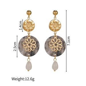 Detailed view of baroque flower earrings with grey marble disc and white teardrop pearl