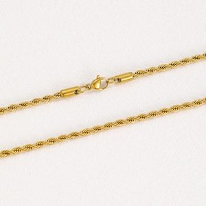 Macro shot of gold-plated twisted rope chain necklace with a secure lobster clasp