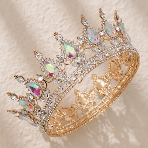 Detail of golden Baroque crown featuring luxury pink rhinestones and colorful gemstones