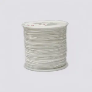 Detailed macro view of white 0.8mm braided cord on spindle for DIY jewelry making