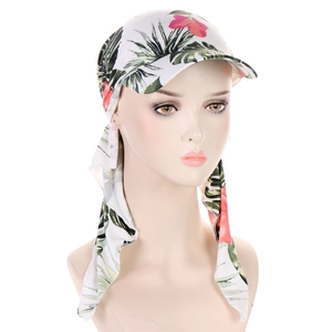 Detailed view of floral headwrap cap with brim and long ties on a mannequin