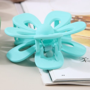Frosted mint green flower hair claw clip with large petal design and matte finish