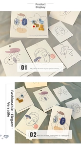 Artistic display of floral and heart earrings on minimalist line art earring cards