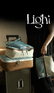 Detail of blue nylon and canvas travel storage bags stacked on a suitcase in a bright scene
