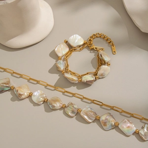 Detail of double-layer stainless steel jewelry set with natural irregular shell beads