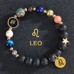 Macro shot of Leo zodiac beaded bracelet with blue sand stone and gold Leo charms