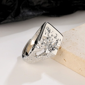 Detailed macro view of silver lava ring featuring irregular textures and hollow geometric design