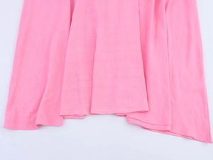 Detail of pink fabric texture showing natural drape and hem of the long dress
