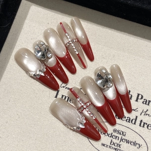 Red French long stiletto press-on nails with rhinestone cross and pearl cat eye finish