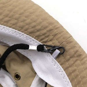 Detail of khaki sun hat with breathable mesh sweatband, metal eyelets, and chin strap