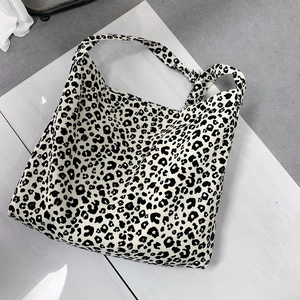 Flat lay of large leopard print corduroy tote bag showing spacious design and canvas texture