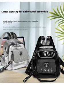 Detail view of mini backpacks with studded 1961 design in silver and black leather