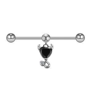 Macro detail of industrial barbell featuring a black devil heart pendant with clear crystal