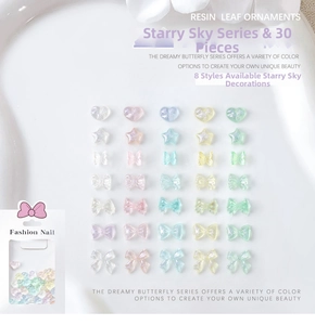 Flat lay of iridescent resin nail charms including bows and hearts in star series