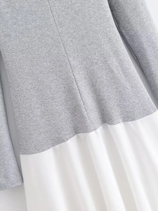 Close-up of grey knit fabric and white material splicing with fine stitching detail