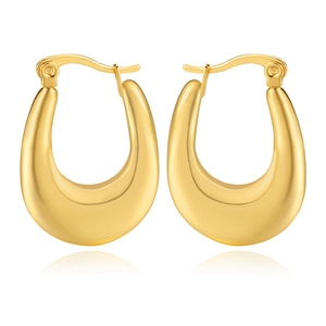 Macro shot of minimalist gold-plated U-shaped hoop earrings with smooth metallic finish