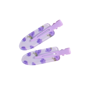 Pair of cute purple acrylic flower hair clips with duckbill design on white background