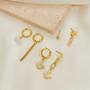 Titanium steel earrings set with pearls, butterfly charms, and tassels in gold plating