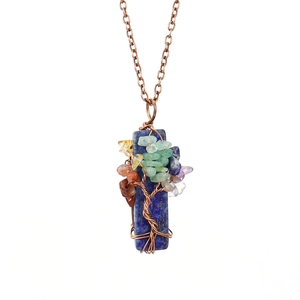 Macro detail of Tree of Life pendant with lapis lazuli and colorful natural stone wire wrap