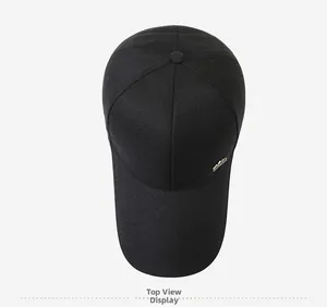 Top view of a black cotton baseball cap with six-panel design and golden metal accent