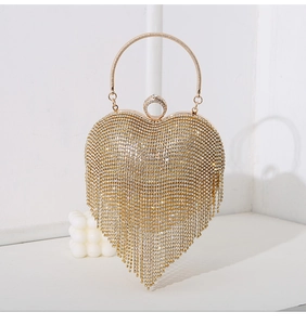 Golden heart-shaped evening clutch with sparkling rhinestones and long tassel fringe detail