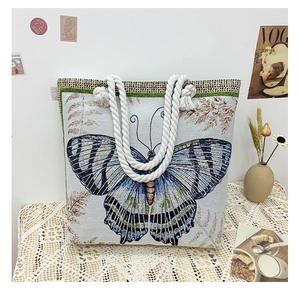 Close-up of jacquard canvas tote bag featuring butterfly pattern and rope handles